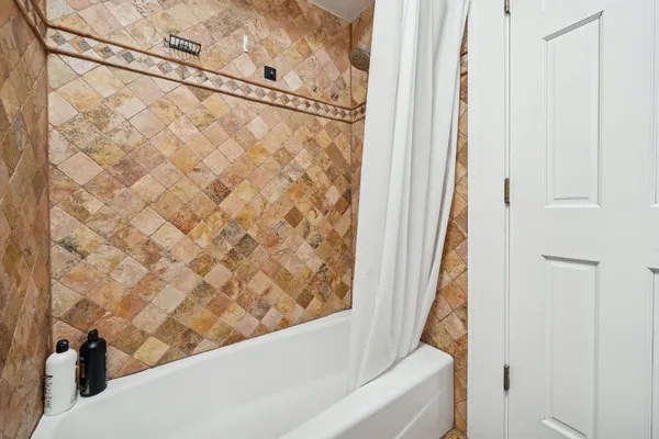 a bathroom with a bathtub and shower
