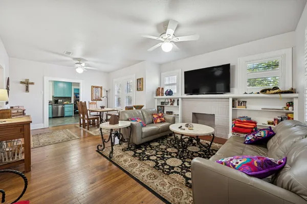 a living room with furniture a flat screen tv and a fireplace
