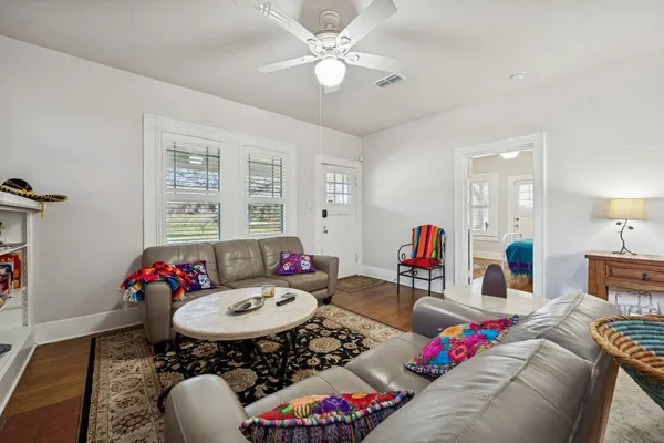 a living room with furniture chess floor and white walls