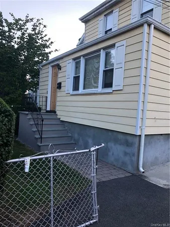a view of a house with wooden fence