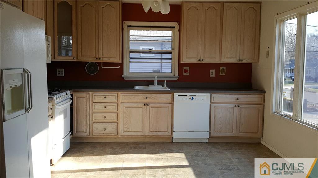 767 Magnolia Road North Brunswick, NJ 08902 - Photo 4 of 15 a kitchen with granite countertop a sink cabinets and a window