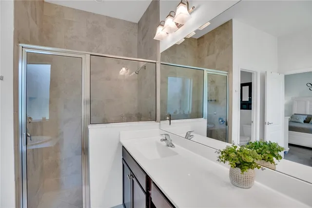 a bathroom with a sink a shower and a mirror