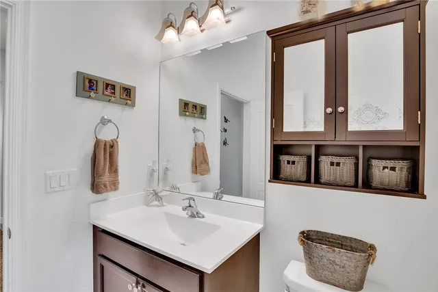 a bathroom with a sink vanity and mirror