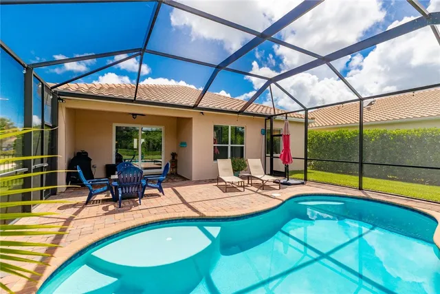 a view of swimming pool with outdoor seating