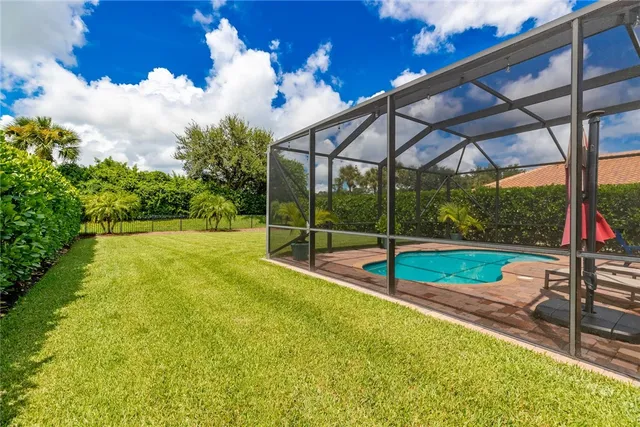a view of a backyard with swimming pool