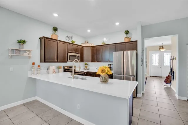 a kitchen with a sink appliances and cabinets