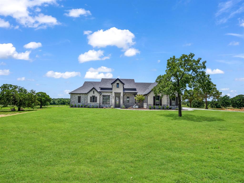 148 Daggett Drive Decatur, TX 76234 - Photo 5 of 36 a house view with garden space and trees