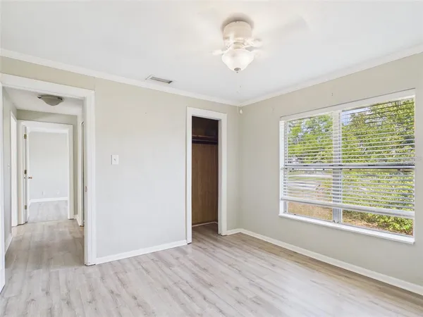 a view of an empty room with wooden floor