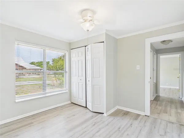 a view of an empty room with wooden floor