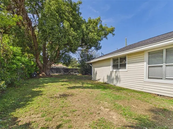 a view of a house with a yard and sitting area