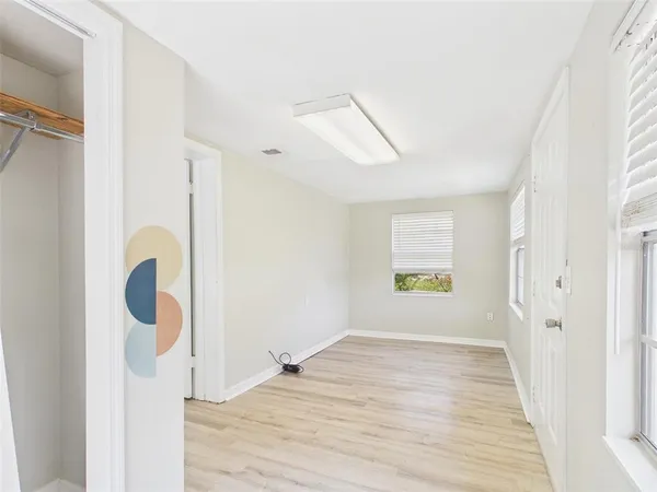 a view of a kitchen with wooden floor and cabinet