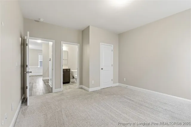 a view of a big room with closet and windows