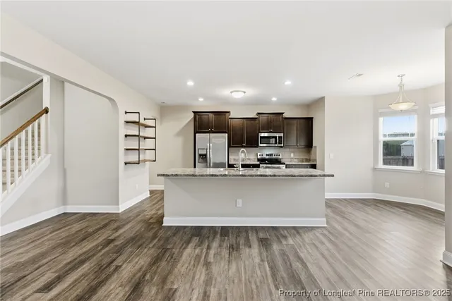 a view of kitchen with sink microwave and refrigerator