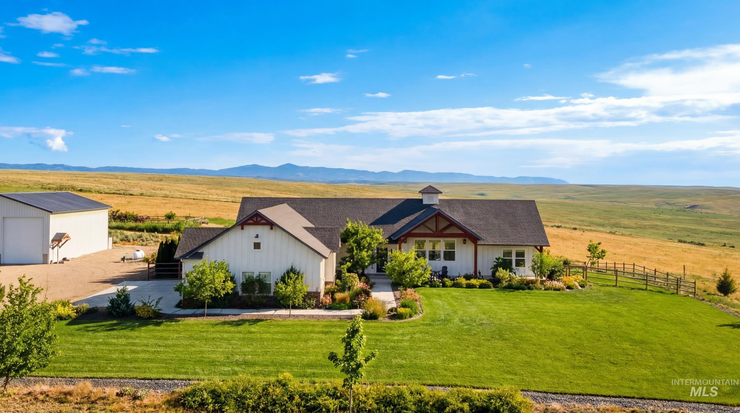 5800 Partridge Peak Avenue Caldwell, ID 83607 - Photo 1 of 50 View of front of home featuring an outdoor structure, a rural view, board and batten siding, and a mountain view