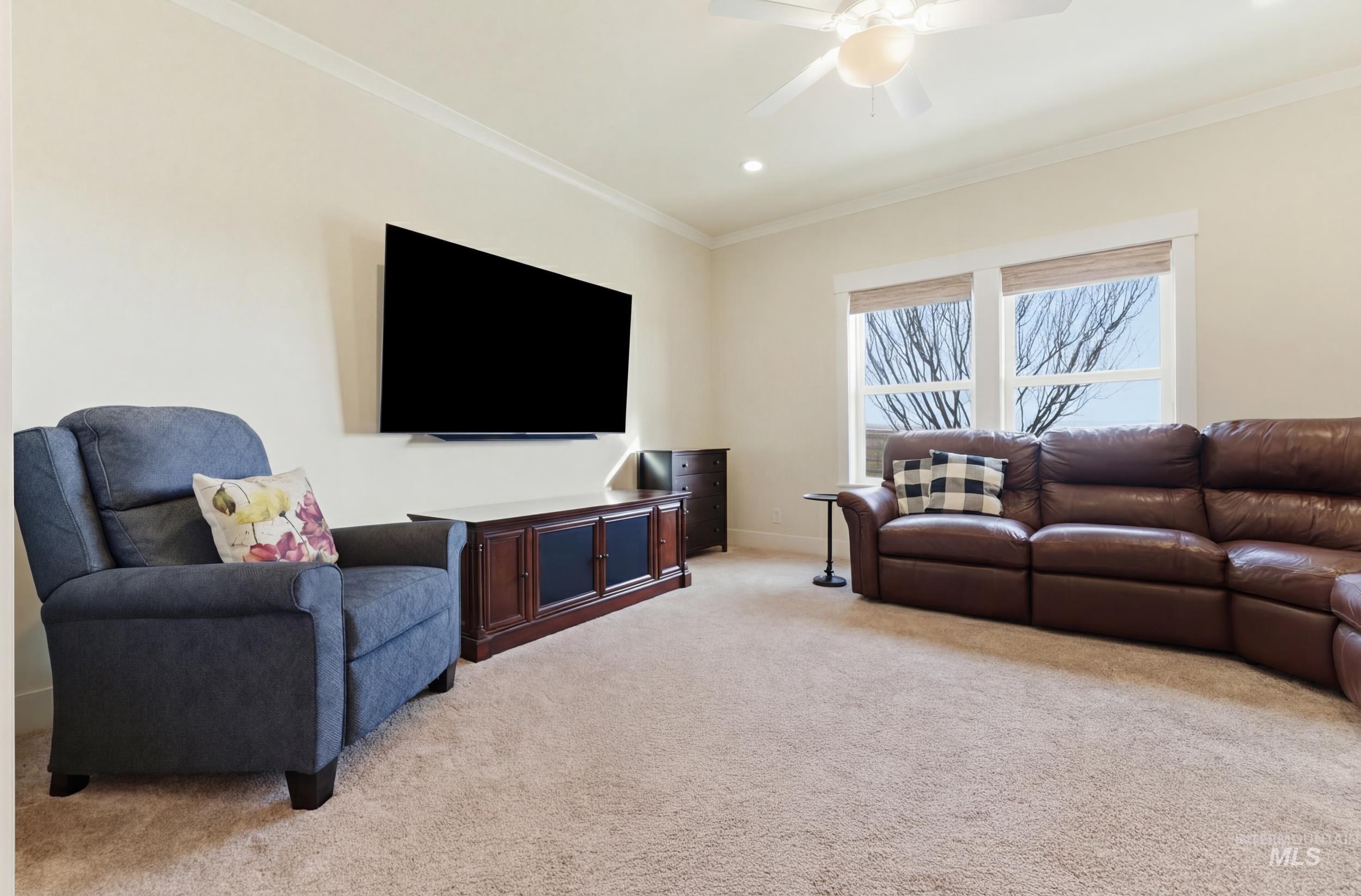 5800 Partridge Peak Avenue Caldwell, ID 83607 - Photo 23 of 50 Living area with light carpet, crown molding, a ceiling fan, and recessed lighting