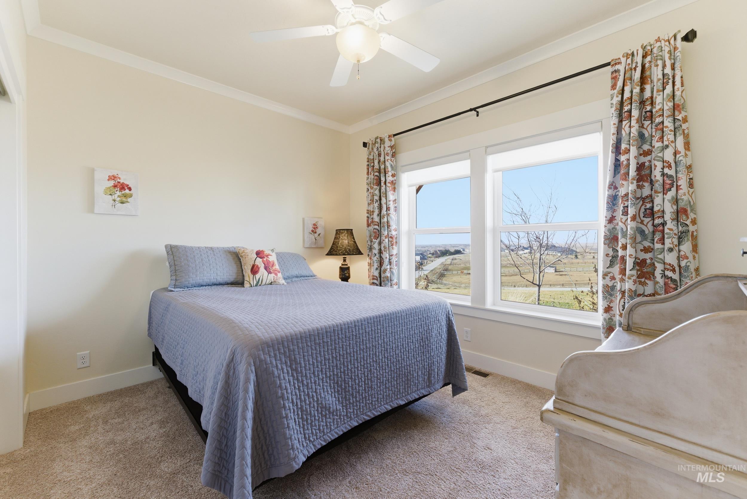 5800 Partridge Peak Avenue Caldwell, ID 83607 - Photo 25 of 50 Bedroom featuring crown molding, light colored carpet, and a ceiling fan