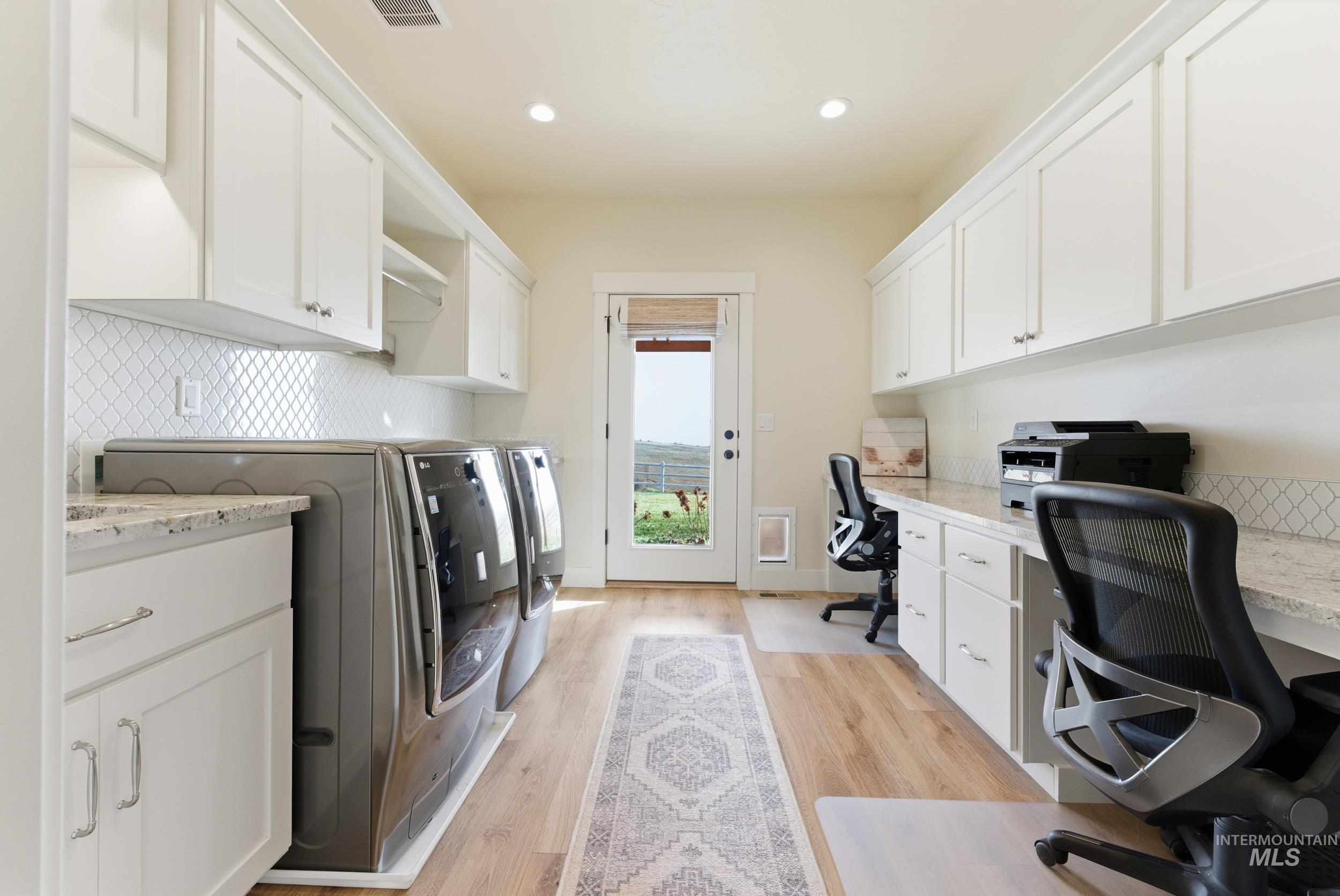 5800 Partridge Peak Avenue Caldwell, ID 83607 - Photo 34 of 50 Laundry area featuring a desk, light wood-style flooring, washer and dryer, and recessed lighting
