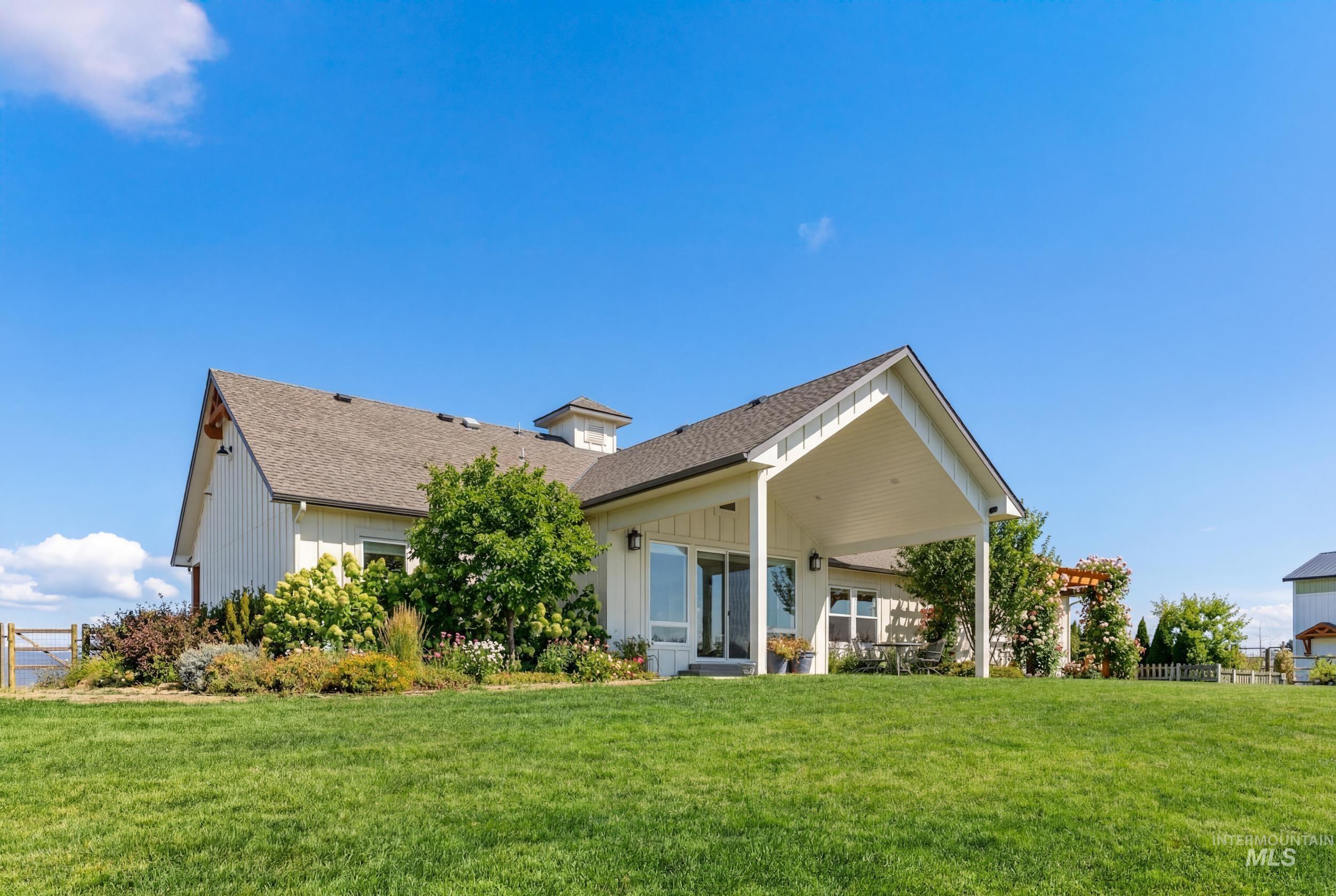 5800 Partridge Peak Avenue Caldwell, ID 83607 - Photo 37 of 50 Back of property featuring a patio, board and batten siding, and roof with shingles
