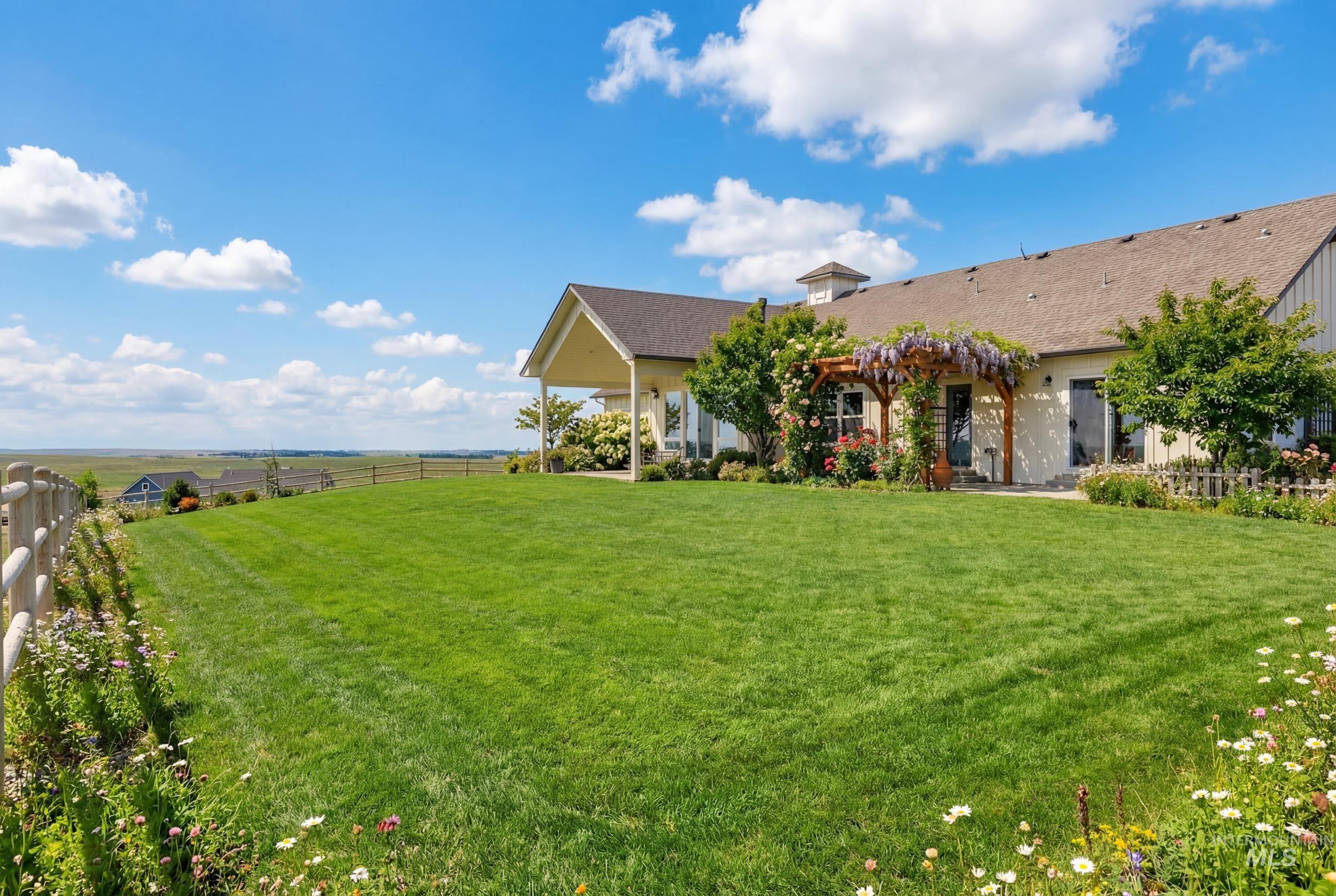 5800 Partridge Peak Avenue Caldwell, ID 83607 - Photo 38 of 50 View of yard featuring a pergola, a patio, and a view of countryside