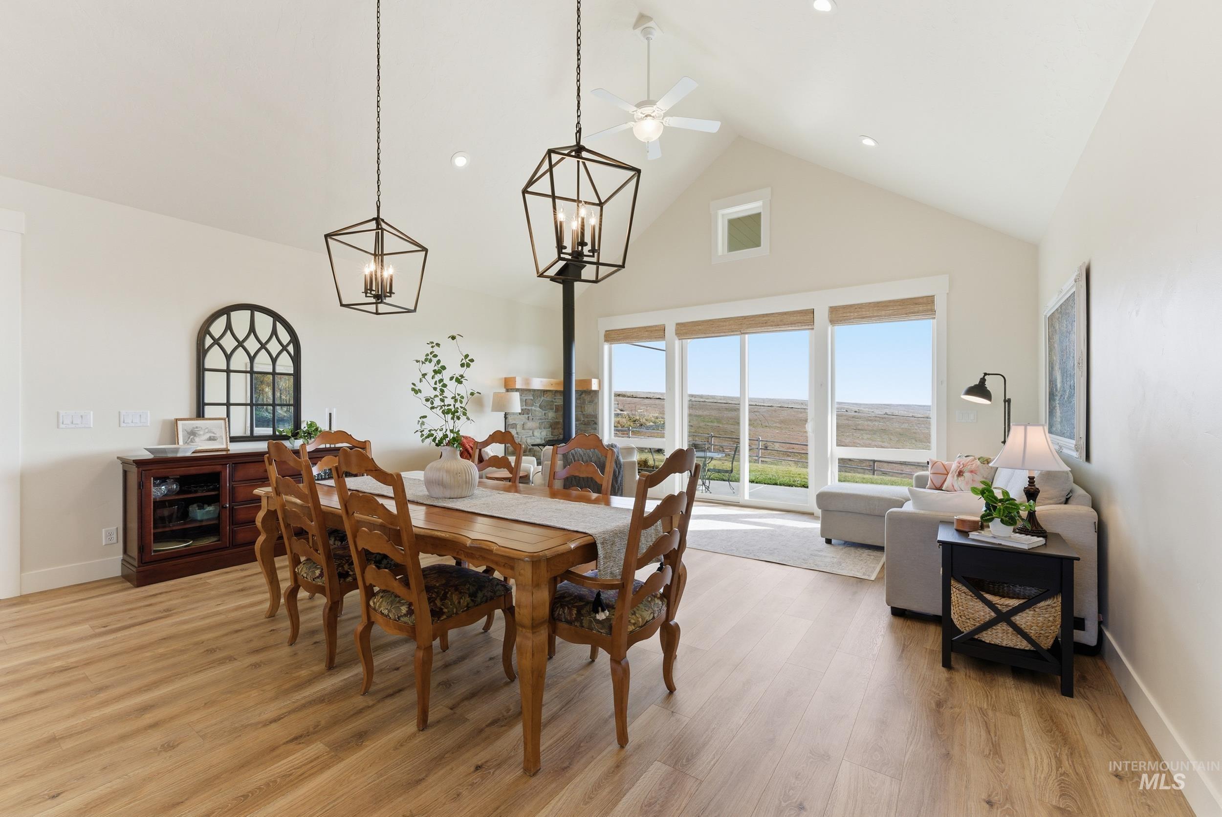 5800 Partridge Peak Avenue Caldwell, ID 83607 - Photo 7 of 50 Dining space with light wood-style flooring, hanging lights, lofted ceiling, and a ceiling fan