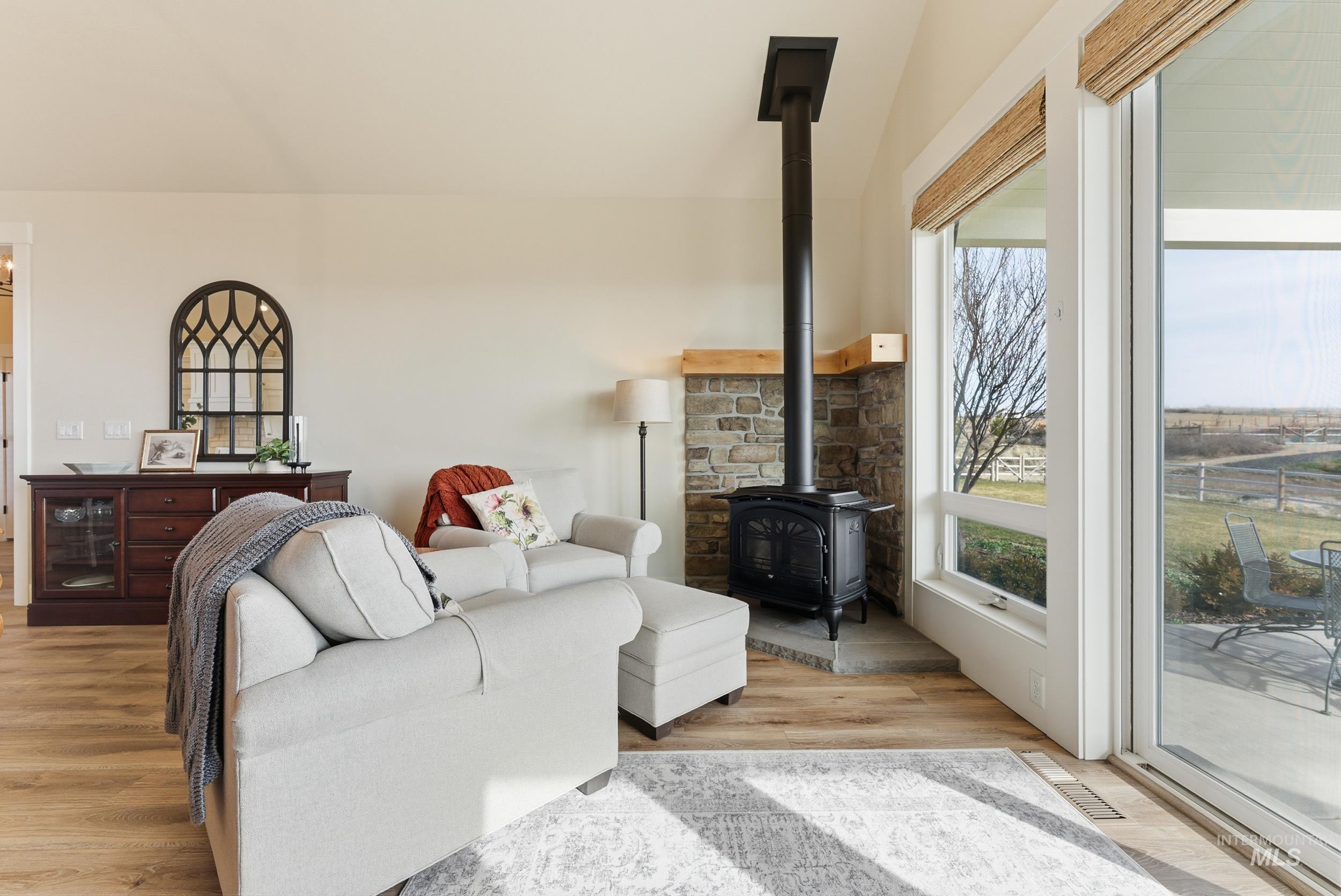 5800 Partridge Peak Avenue Caldwell, ID 83607 - Photo 9 of 50 Living room with a wood stove and light wood-style flooring
