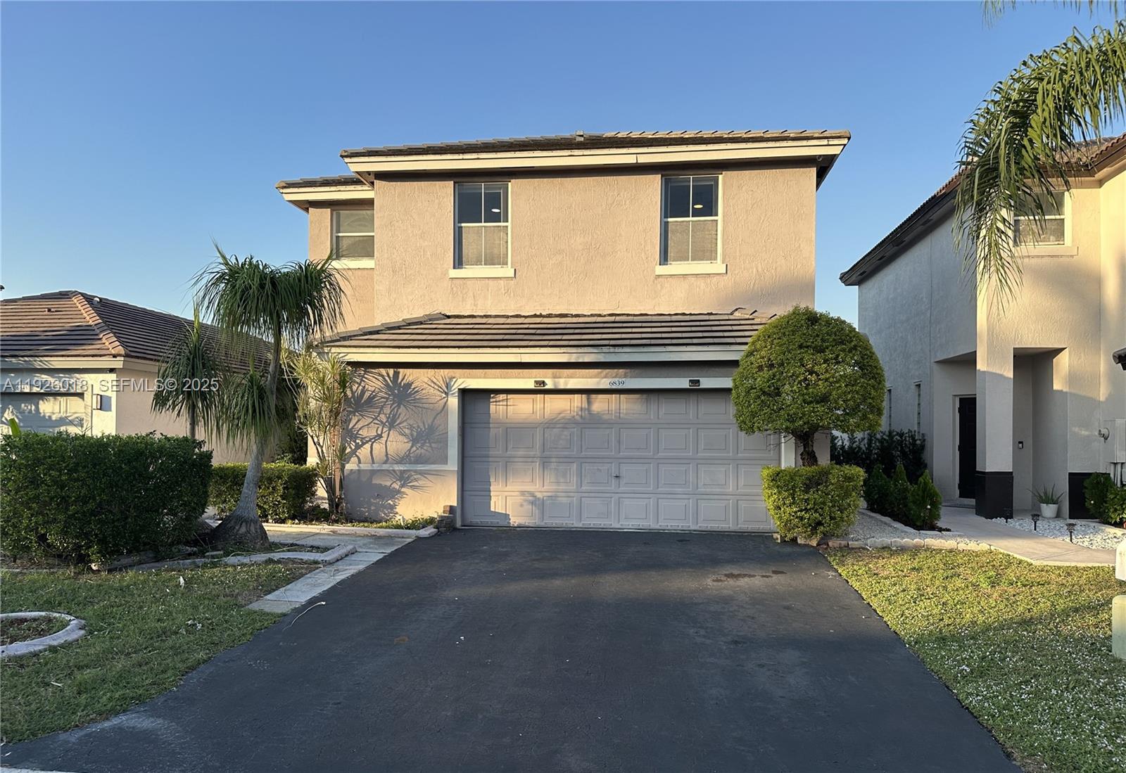 a view of a house with a yard and garage