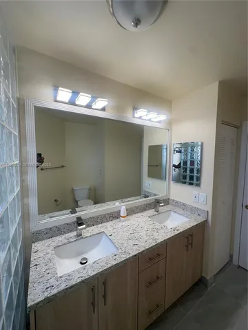 a bathroom with a sink double vanity and a mirror