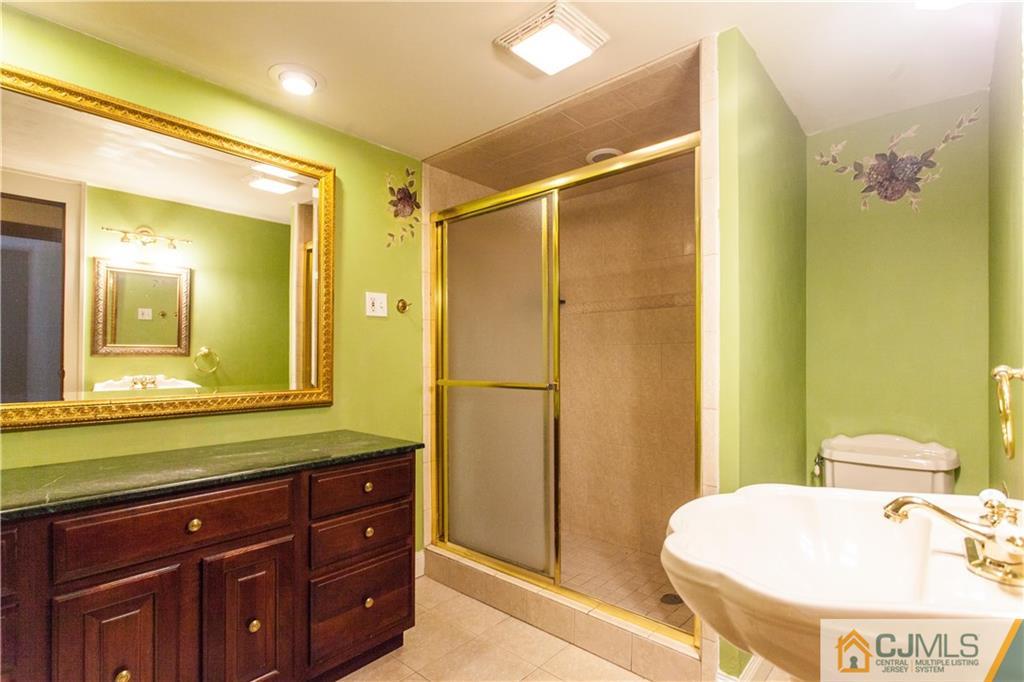 29 Maida Road Edison, NJ 08820 - Photo 14 of 17 a bathroom with a sink and a mirror