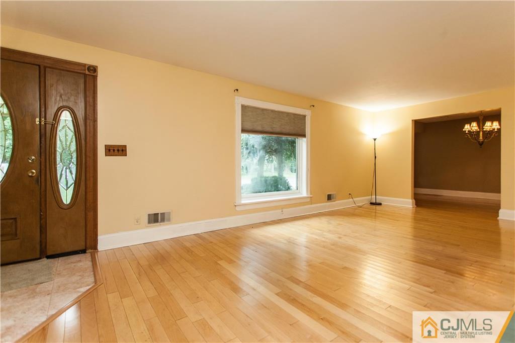 29 Maida Road Edison, NJ 08820 - Photo 3 of 17 a view of an empty room with window and wooden floor