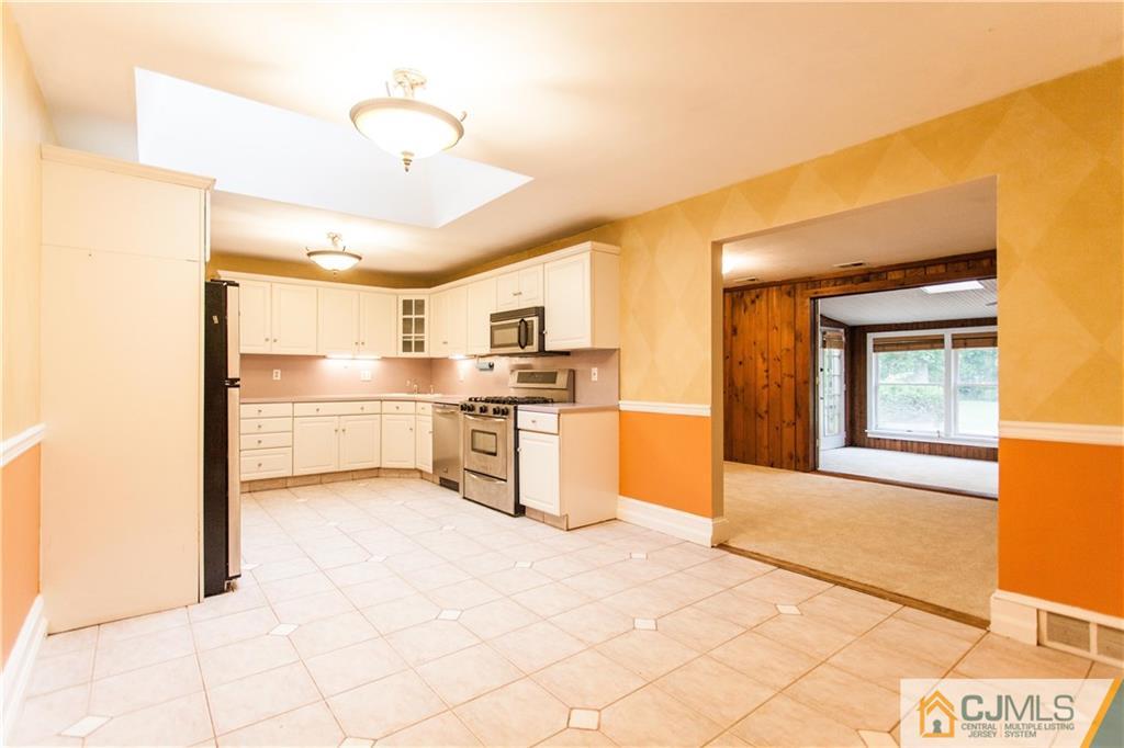 29 Maida Road Edison, NJ 08820 - Photo 5 of 17 a view of a kitchen with wooden floor and a refrigerator