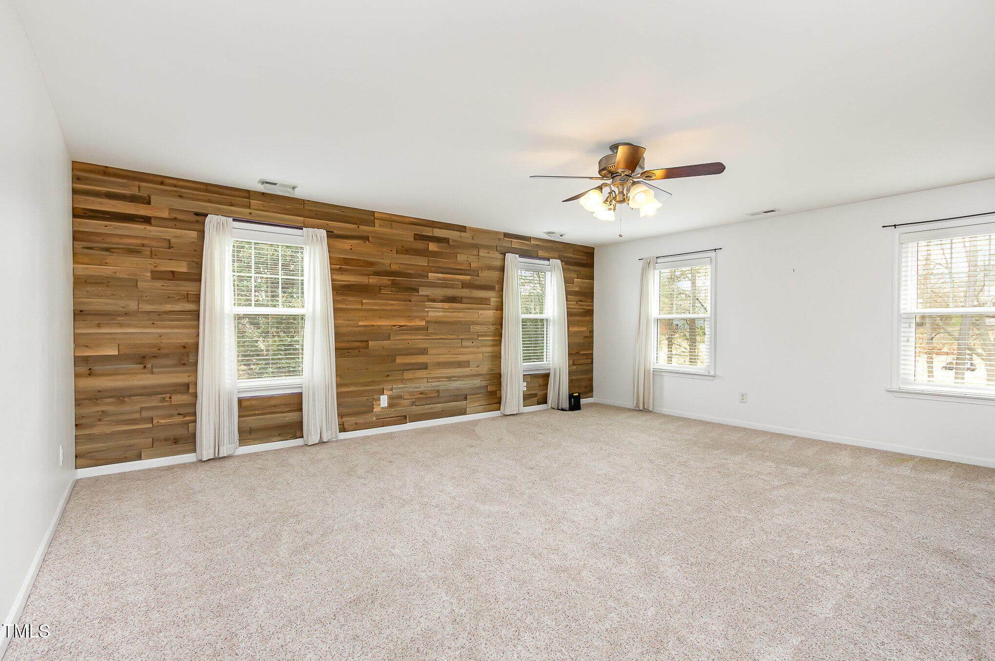 405 Challenge Road Raleigh, NC 27603 - Photo 9 of 24 a view of a livingroom with a ceiling fan and window