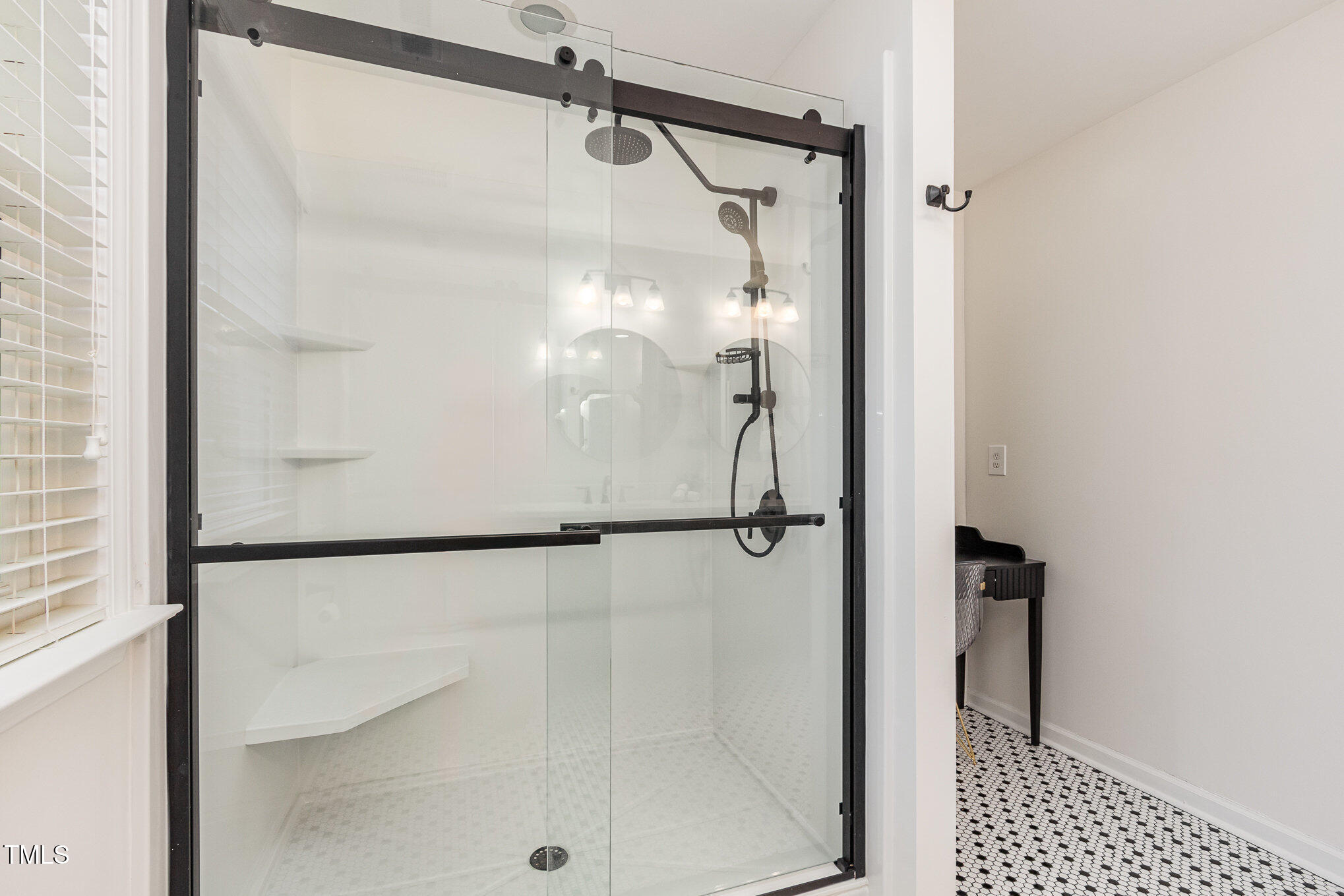 405 Challenge Road Raleigh, NC 27603 - Photo 10 of 24 a bathroom with a glass shower door
