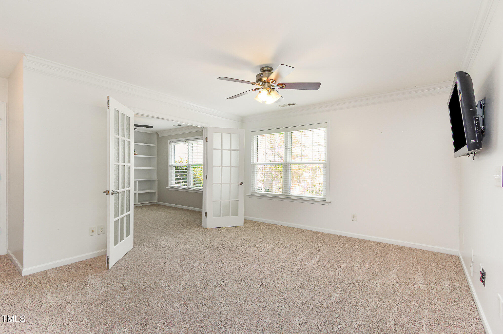 405 Challenge Road Raleigh, NC 27603 - Photo 12 of 24 a view of a livingroom with an empty space and a ceiling fan