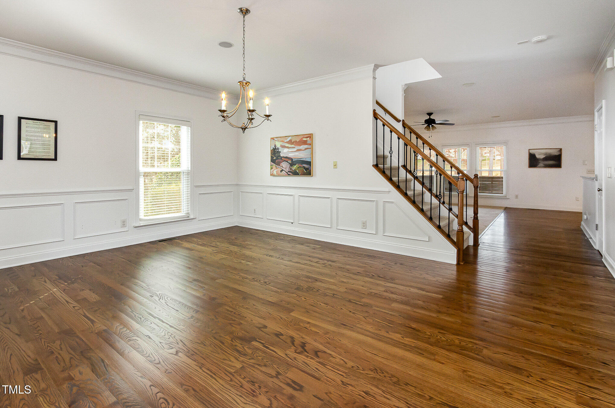 405 Challenge Road Raleigh, NC 27603 - Photo 3 of 24 a view of an room with wooden floor chandelier and windows
