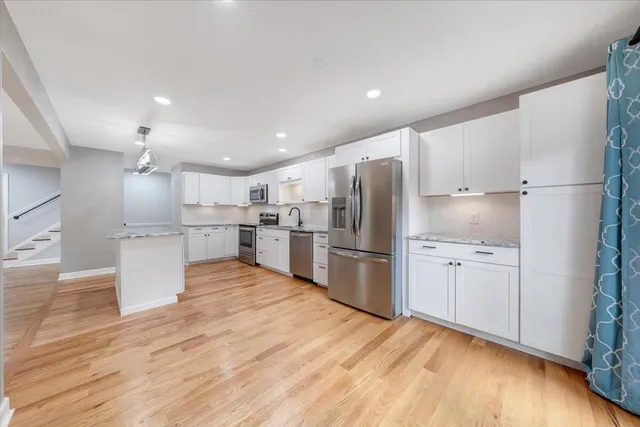 a kitchen with granite countertop a sink and cabinets