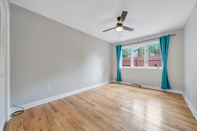 a view of a livingroom with wooden floor a fireplace and window