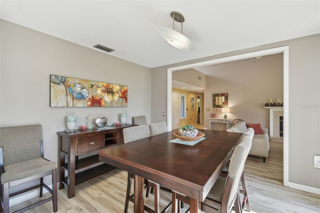 5434 Kemkerry Road Wesley Chapel, FL 33543 - Photo 13 of 56 a view of a dining room with furniture and wooden floor