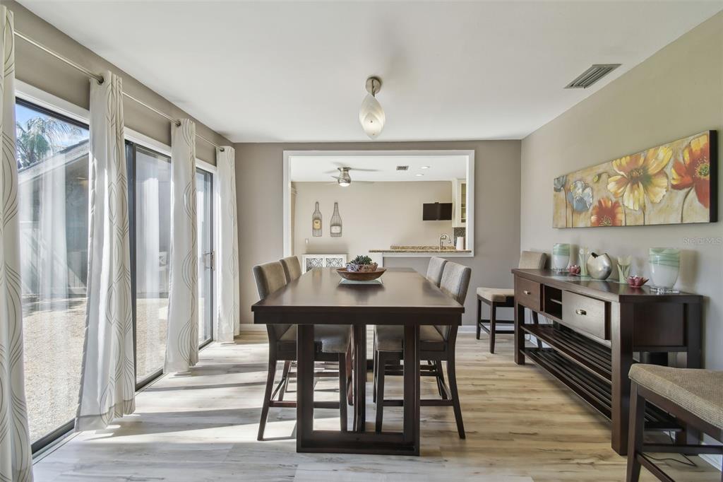 5434 Kemkerry Road Wesley Chapel, FL 33543 - Photo 14 of 56 a view of a a dining room with furniture window and wooden floor