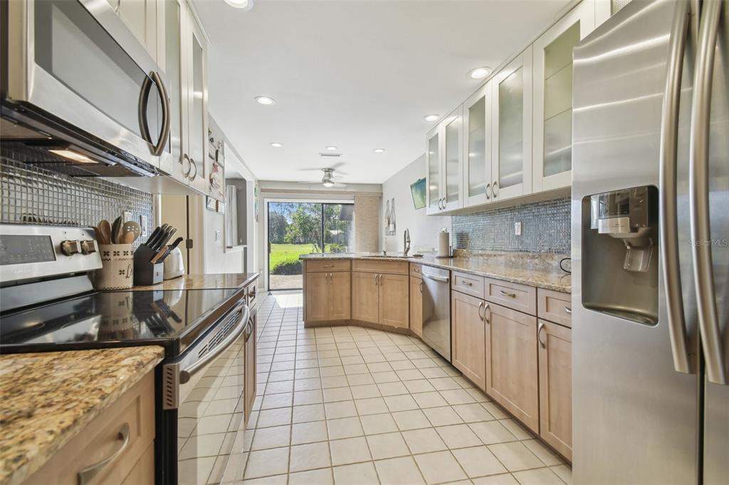 5434 Kemkerry Road Wesley Chapel, FL 33543 - Photo 20 of 56 a kitchen with stainless steel appliances granite countertop a refrigerator and a sink