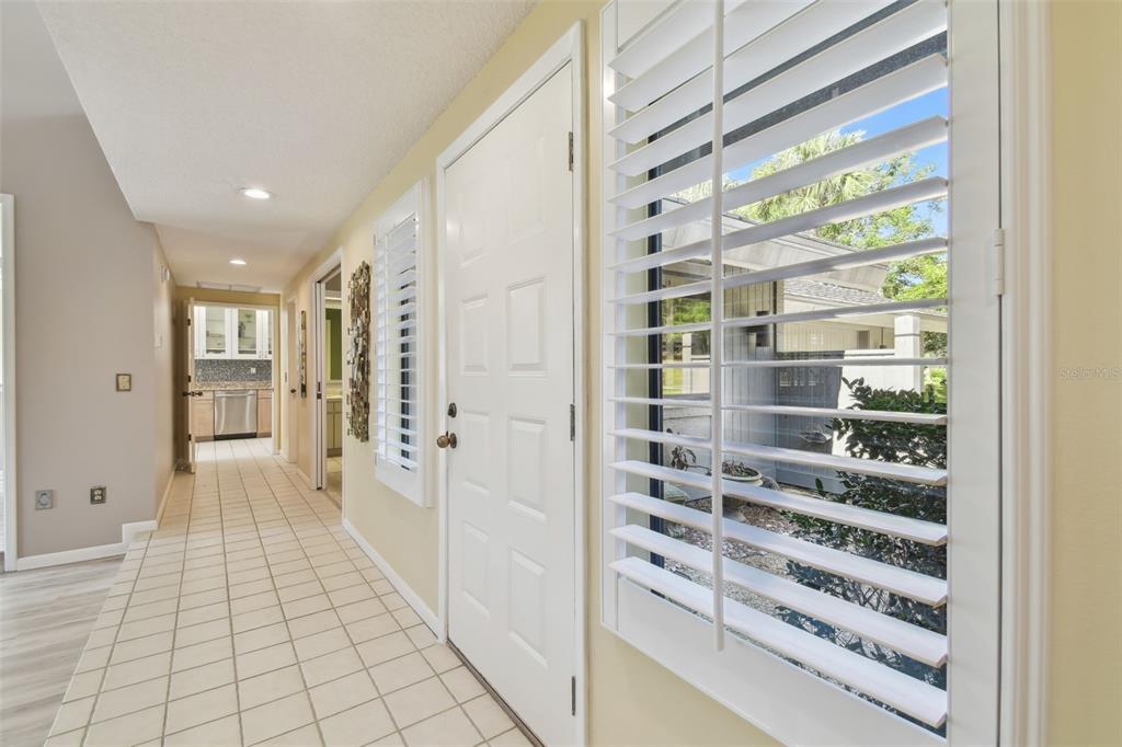 5434 Kemkerry Road Wesley Chapel, FL 33543 - Photo 28 of 56 a view of a hallway with wooden floor and windows
