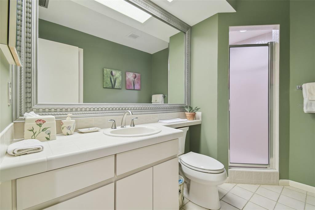 5434 Kemkerry Road Wesley Chapel, FL 33543 - Photo 32 of 56 a bathroom with a toilet sink vanity and mirror