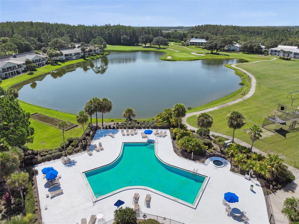 5434 Kemkerry Road Wesley Chapel, FL 33543 - Photo 40 of 56 an aerial view of a house a swimming pool a yard and lake view