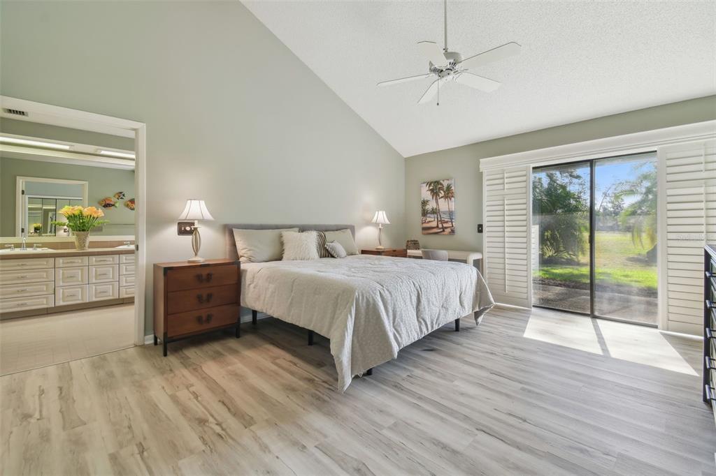 5434 Kemkerry Road Wesley Chapel, FL 33543 - Photo 4 of 56 a spacious bedroom with a bed and wooden floor