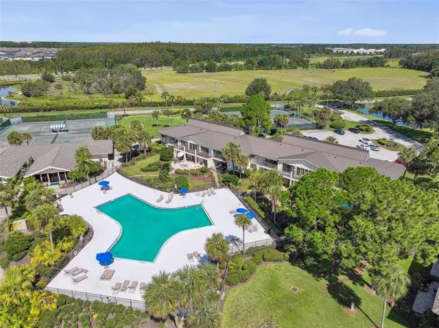 an aerial view of a house with a yard and lake view