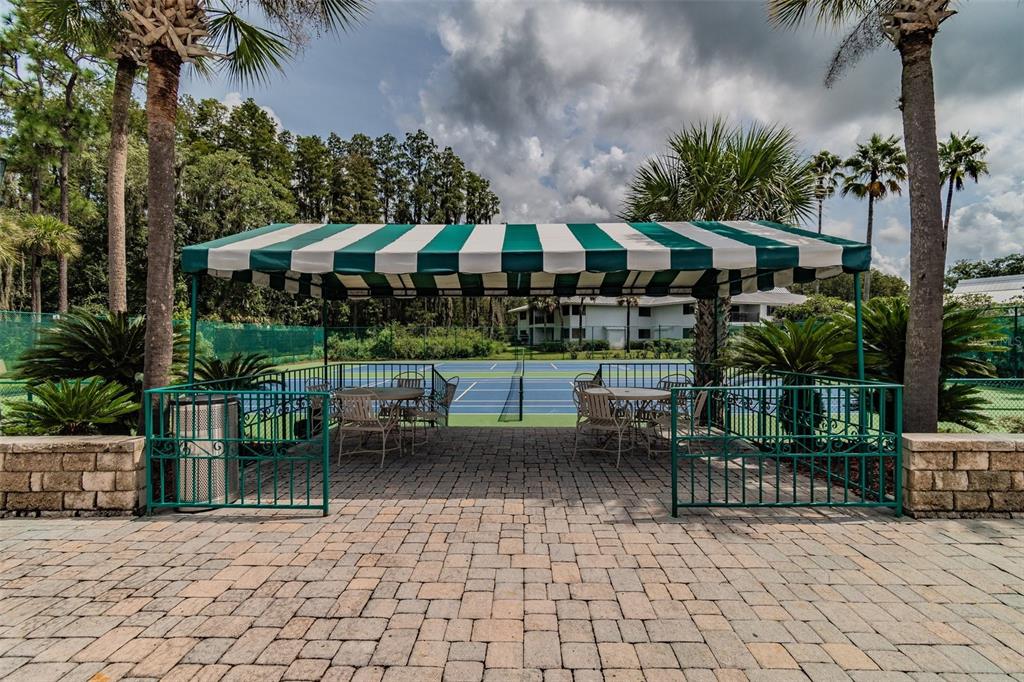 5434 Kemkerry Road Wesley Chapel, FL 33543 - Photo 45 of 56 a view of a patio with a table and chairs under an umbrella