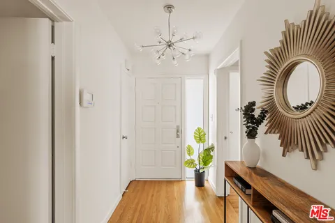 a view of an entryway with wooden floor