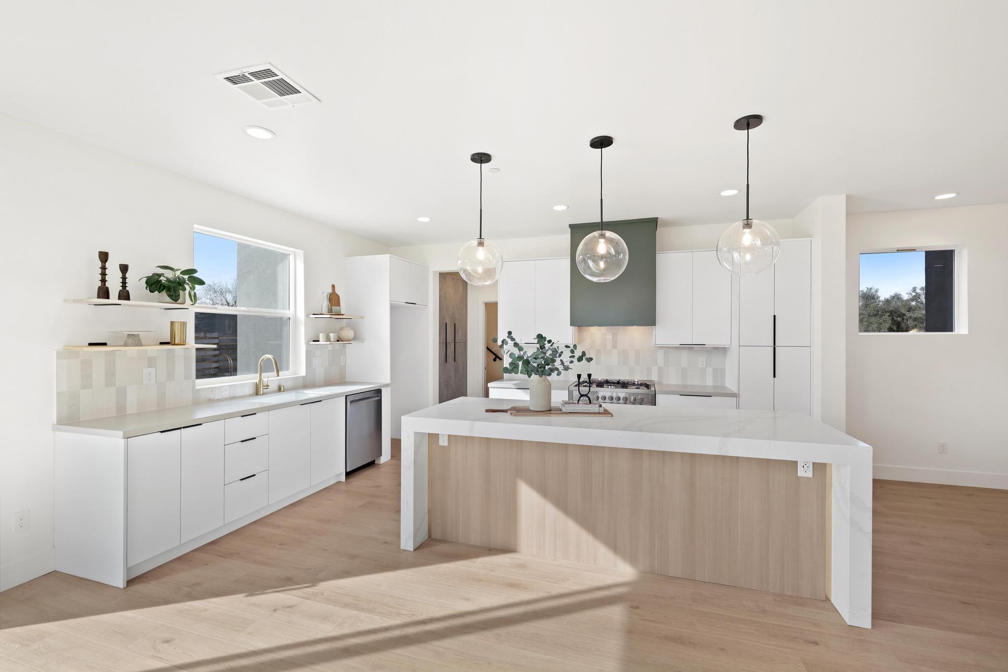 2450 Neighborly Way Redding, CA 96001 - Photo 13 of 48 a large white kitchen with a large island oven a stove and a wooden floors