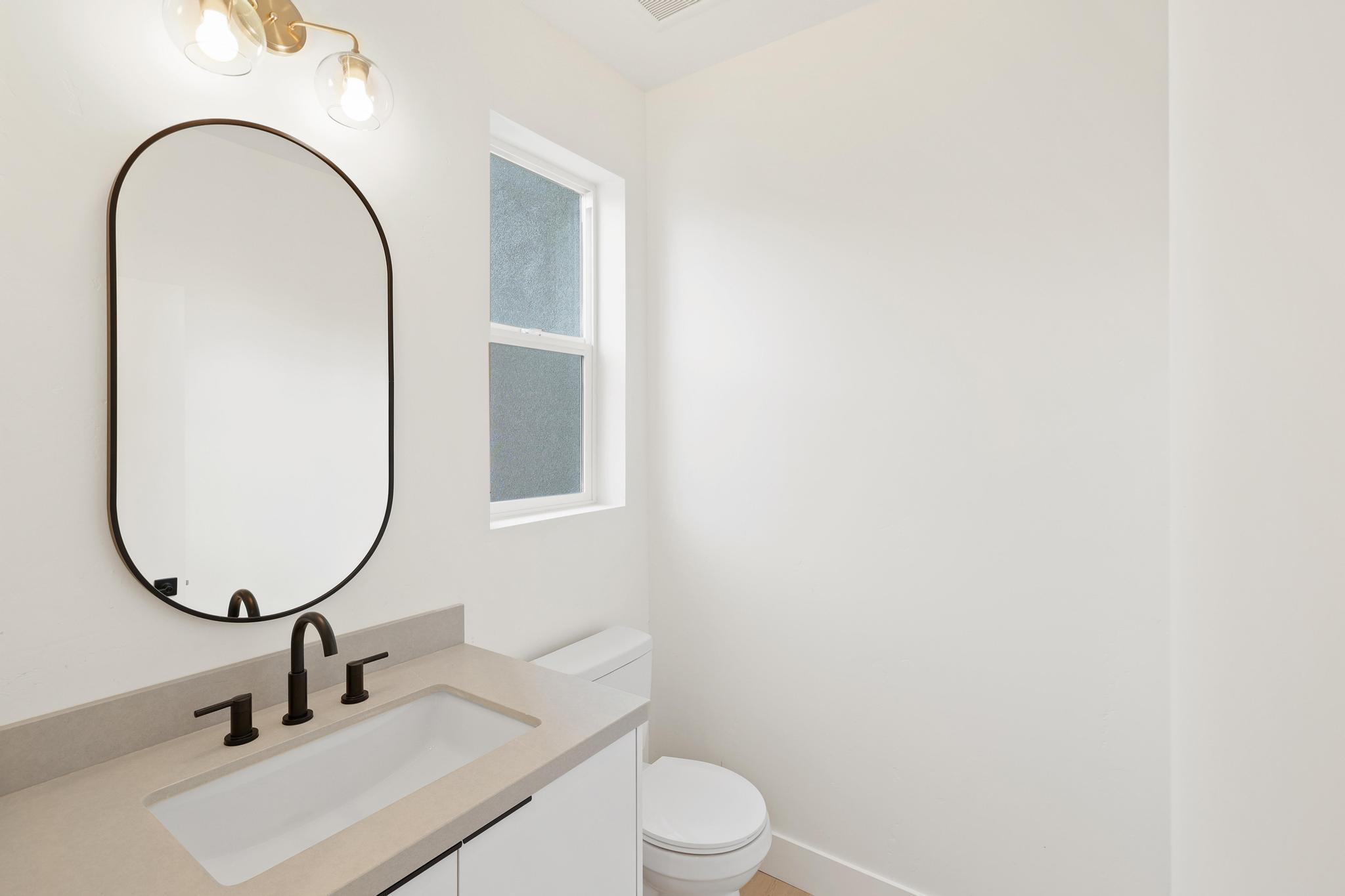 2450 Neighborly Way Redding, CA 96001 - Photo 20 of 48 a bathroom with a toilet a sink and a mirror