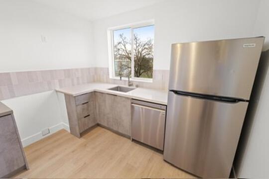2450 Neighborly Way Redding, CA 96001 - Photo 37 of 48 a kitchen with a sink a refrigerator a window and cabinets