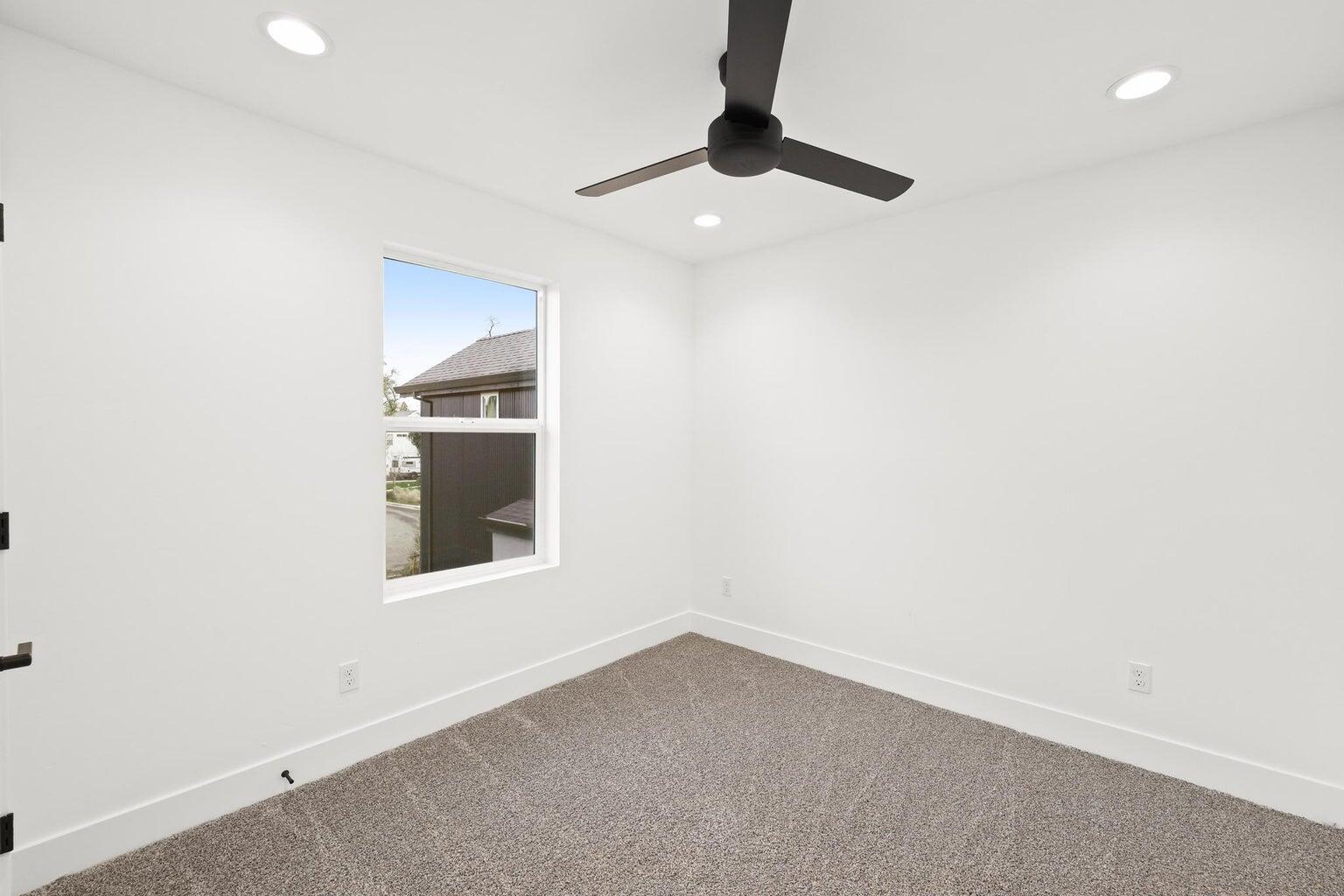 2450 Neighborly Way Redding, CA 96001 - Photo 43 of 48 an empty room with a window and ceiling fan